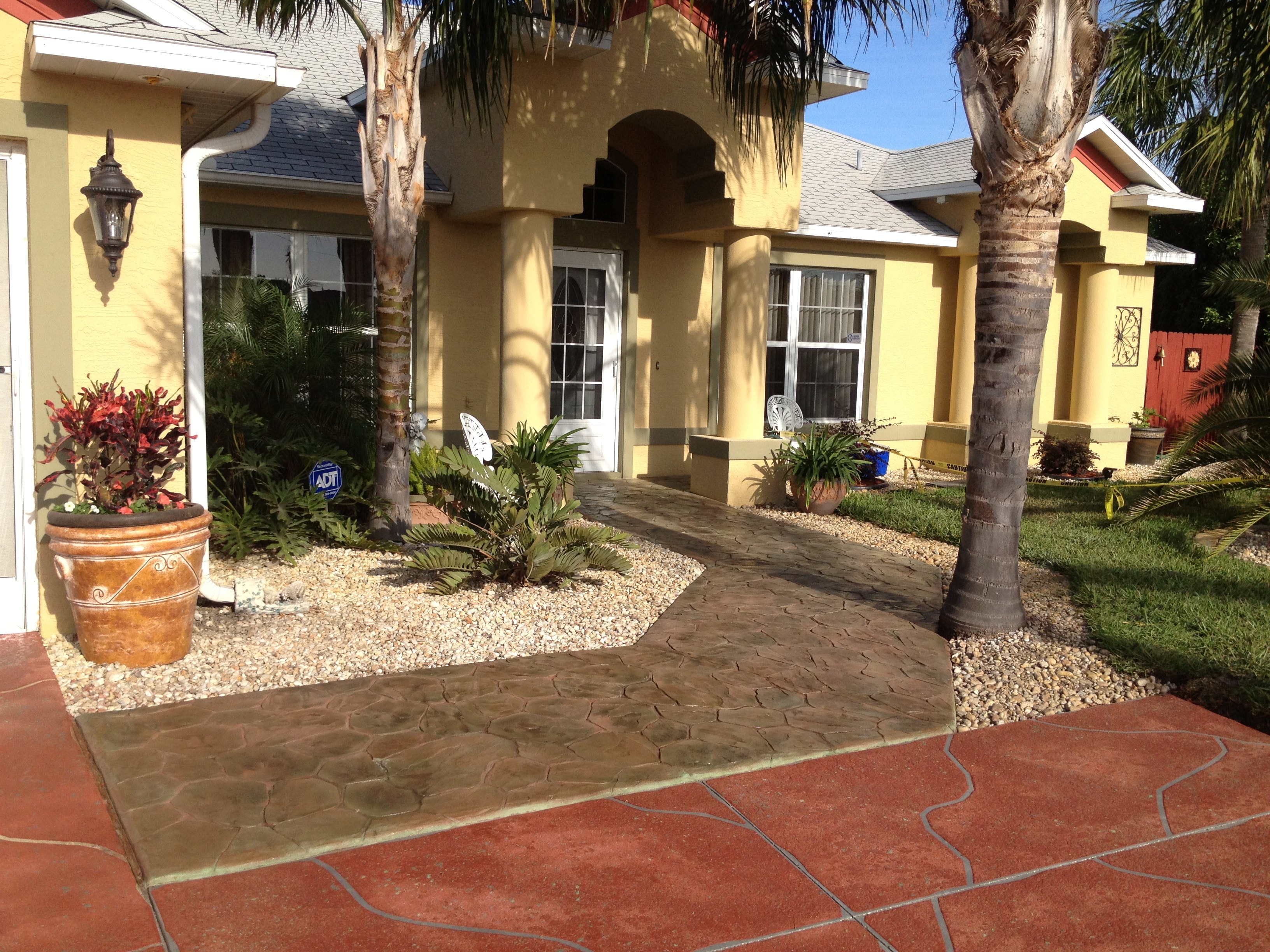 Florida home with palm trees and landscaped driveway