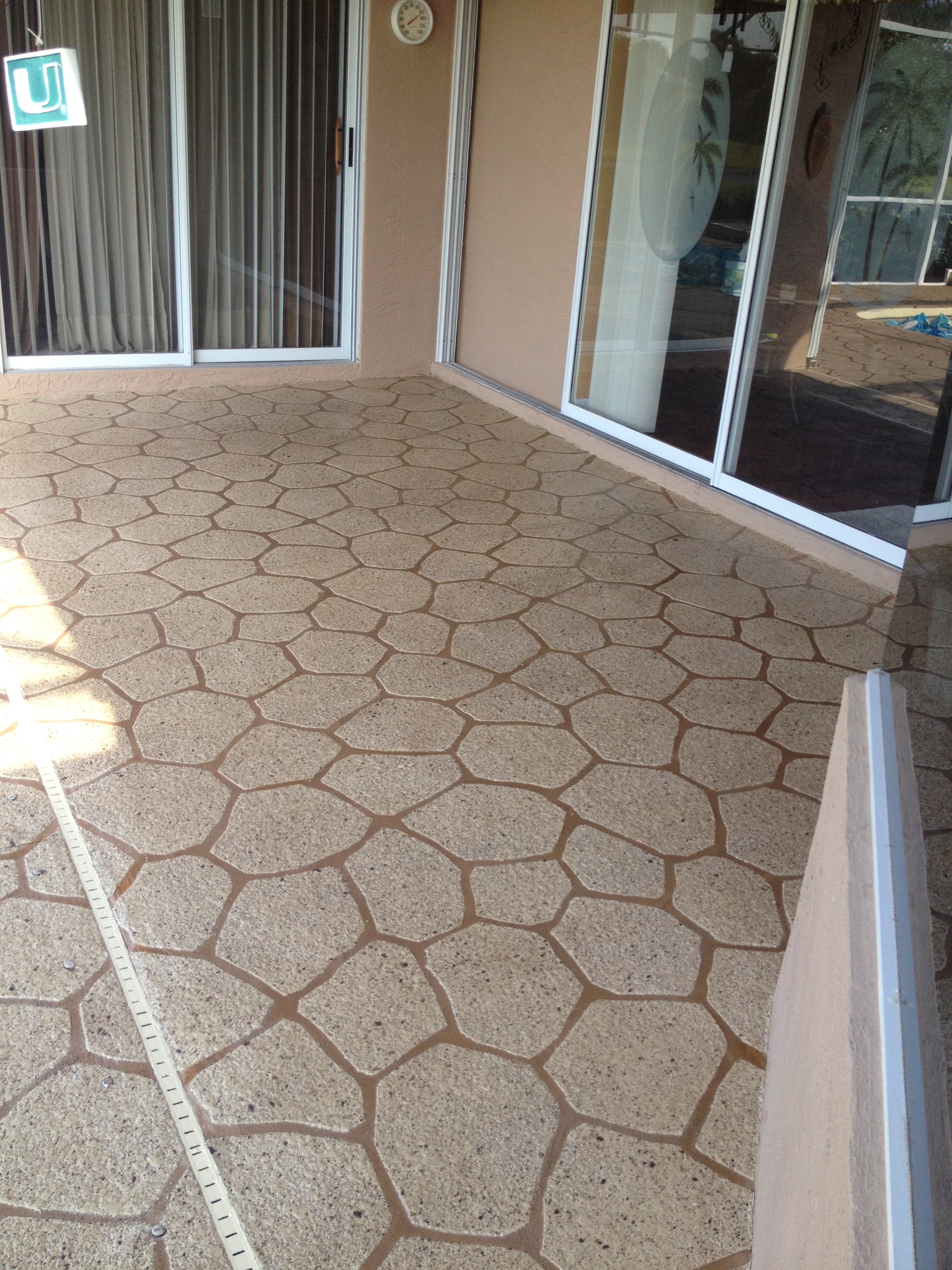 Patterned decorative concrete patio with glass doors